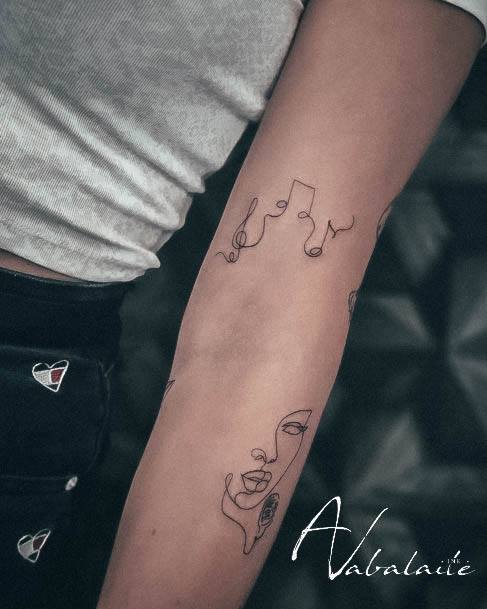 Female Music Note Tattoo On Woman