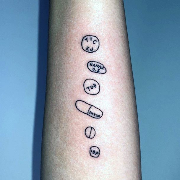 Female Pill Tattoo On Woman