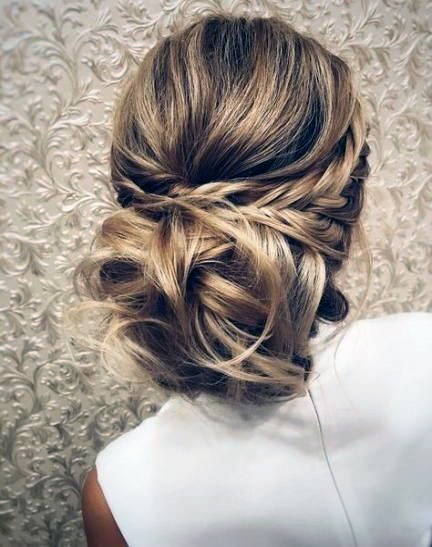 Female Thick Side Braids Leading To Large Curl Bun On Neck