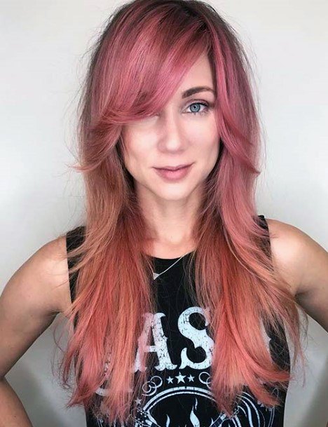 Female With A Long Layered Pink Hairstyle With Fringe