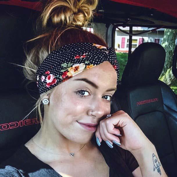 Female With High Hair Knot And Black Polka Dot Headband