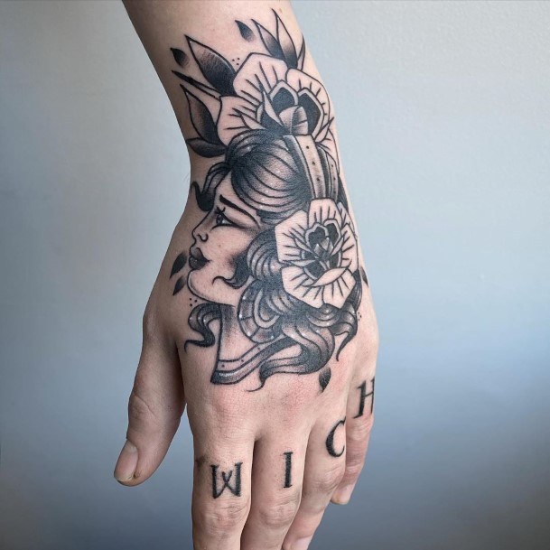 Flowers In Black Womens Hand Tattoo