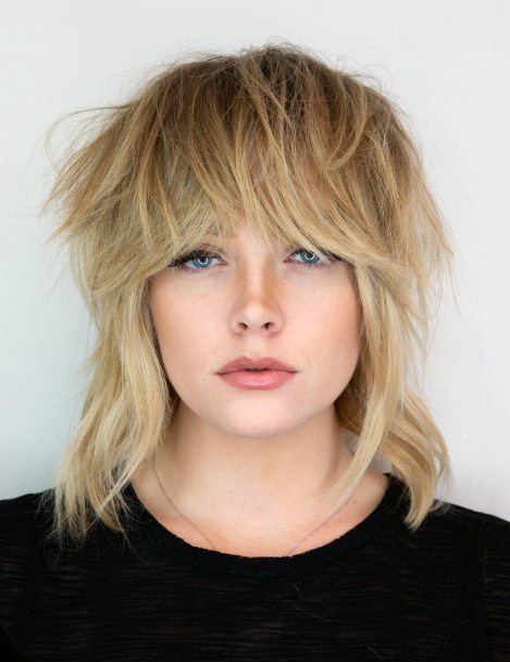 Fringy Shag Haircut On Girl With Medium To Light Blonde Hair Long Bangs