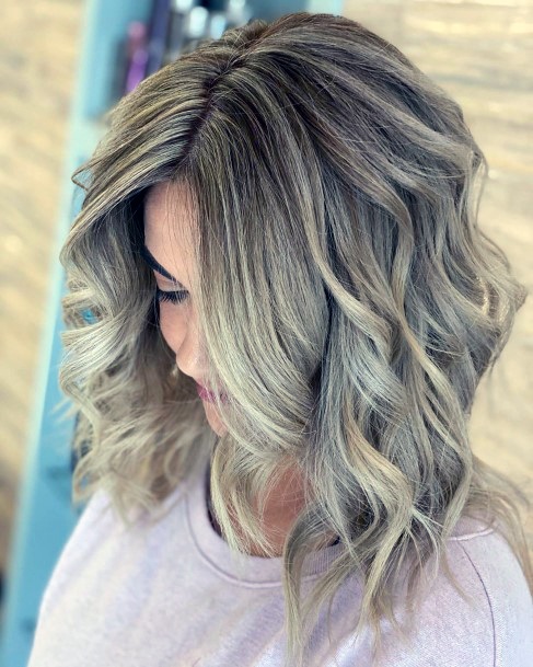 Fun And Flirty Ash Blonde Highlights In Voluminous Curly Womens Hairstyle