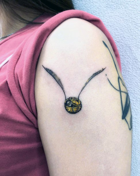 Georgeous Golden Snitch Tattoo On Girl