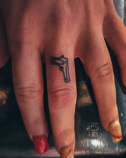 Georgeous Gun Tattoo On Girl Finger