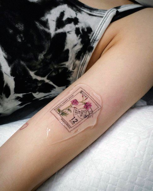 Georgeous Postage Stamp Tattoo On Girl