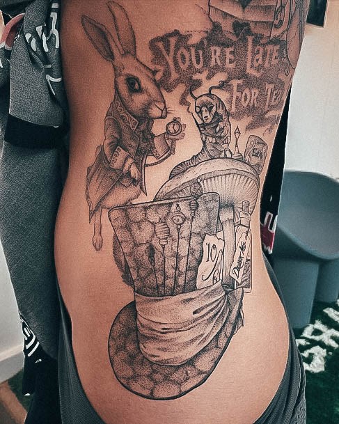 Girl With Feminine Alice In Wonderland Tattoo