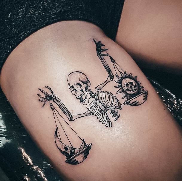 Girl With Feminine Libra Tattoo Thigh Skeleton Holding Balanced Scales