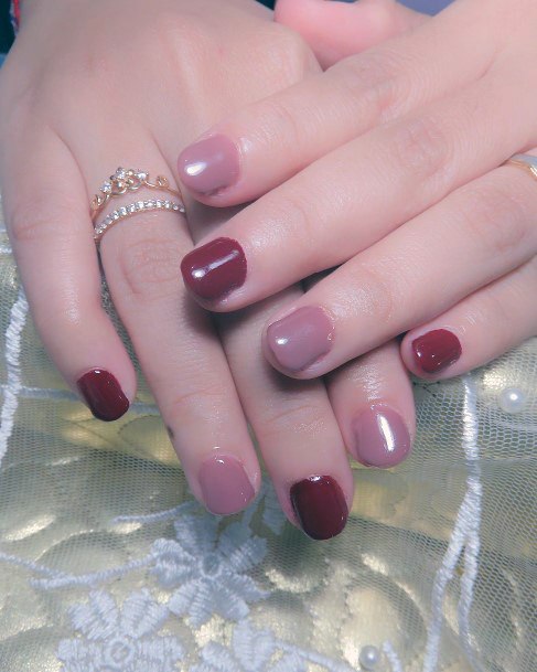 Girl With Feminine Maroon And Pink Nail