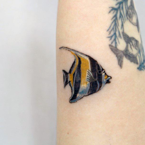 Girl With Graceful Angel Fish Tattoos