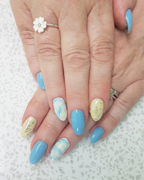 Girl With Graceful Blue And Yellow Nails