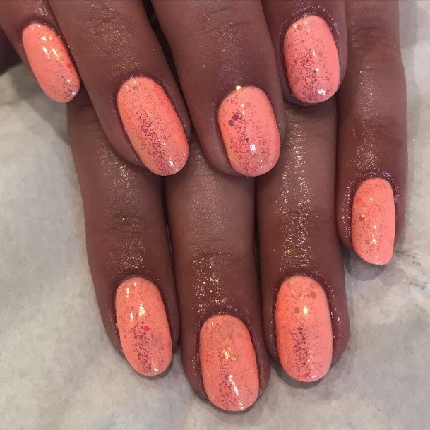 Girl With Graceful Bright Coral Nails