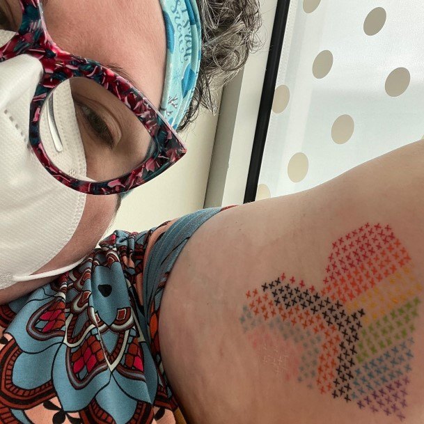 Girl With Graceful Cross Stitch Tattoos