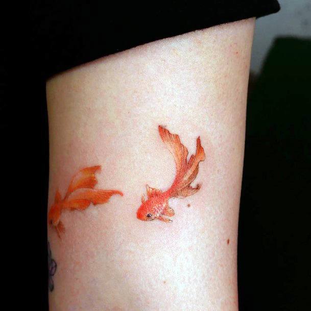 Girl With Graceful Goldfish Tattoos