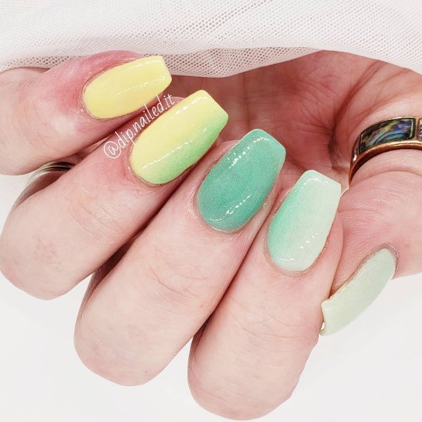 Girl With Graceful Green And Yellow Nails