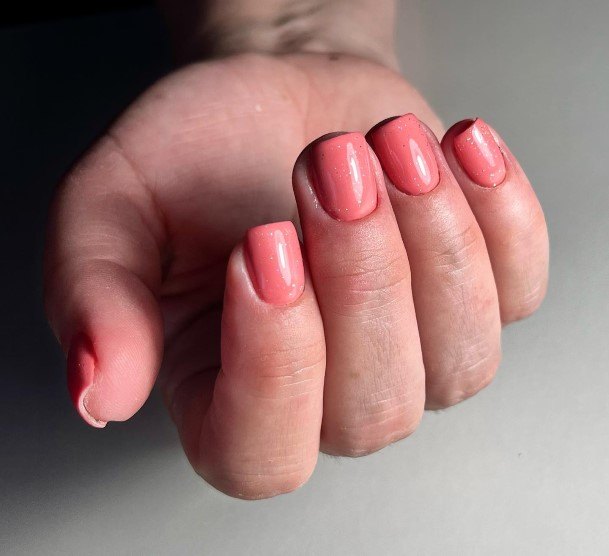 Girl With Graceful Peach And Pink Nails