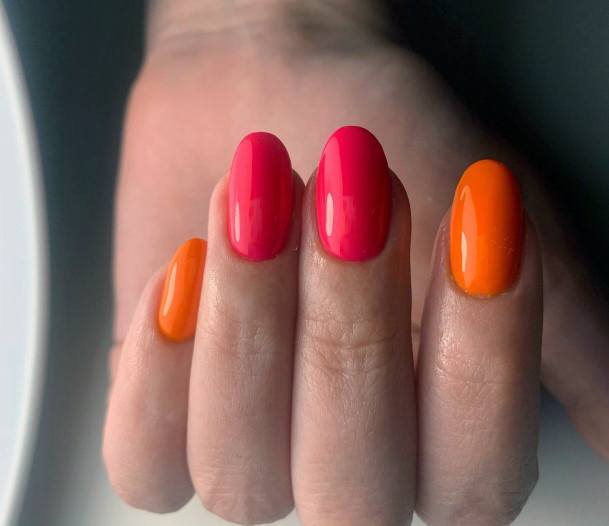 Girl With Graceful Pink And Orange Nails