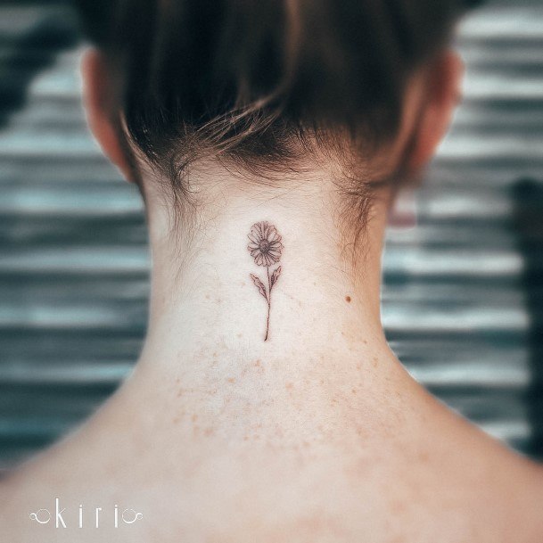 Girl With Stupendous Daisy Tattoos On Back Of Neck