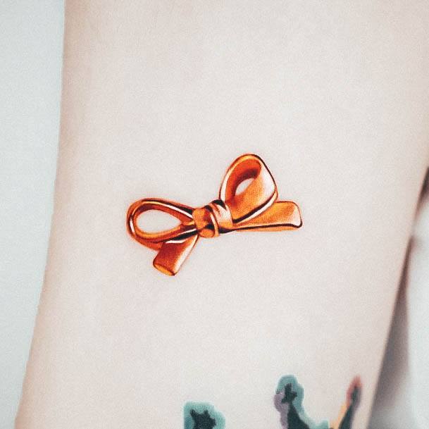 Girl With Stupendous Girly Tattoos Gold Bow Tiny