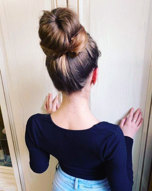 Girl With Thick High Head Bun Secured With Hair Pins