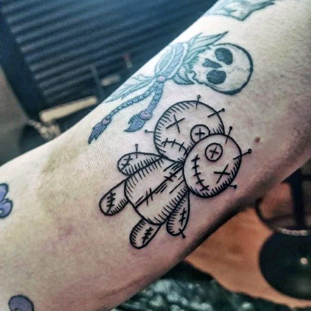 Girls Tattoos With Voodoo Doll