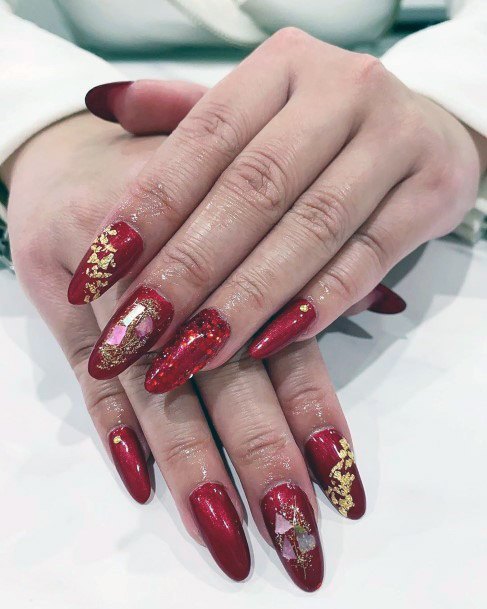 Gleaming Golden Sparkles On Red Nails Women