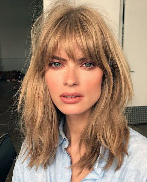 Golden Locks With Center Parted Bangs Hairstyle Women