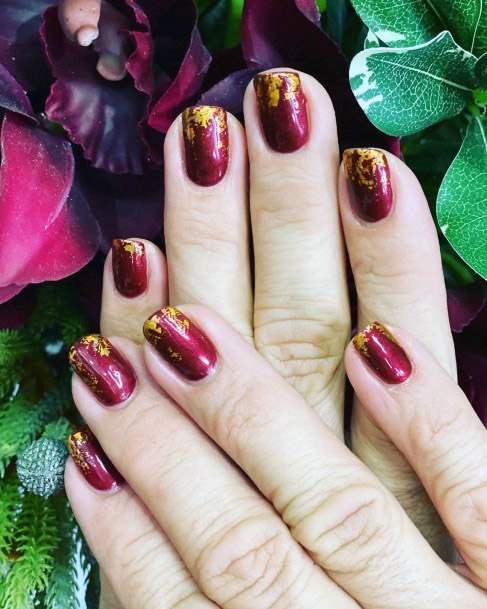 Golden Smatterings On Red Nails Women