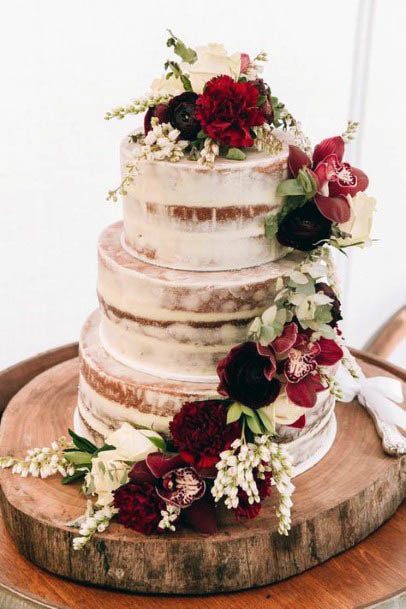 Golden Streaked Wedding Cake With Red Flowers