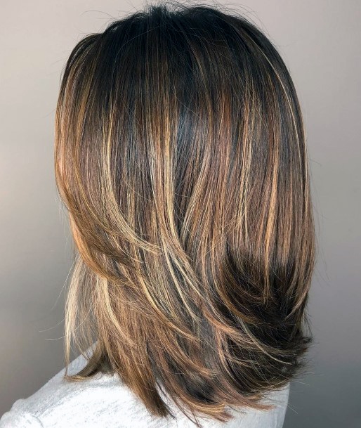 Gorgeous Brown And Blonde Highlighted And Textured Bouncy Women’s Hairstyle