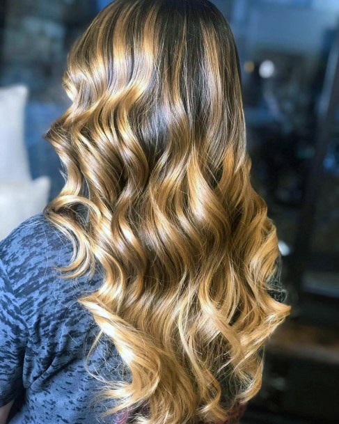 Gorgeous Warm Toned Highlights And Bold Curly Hairstyle For Girls