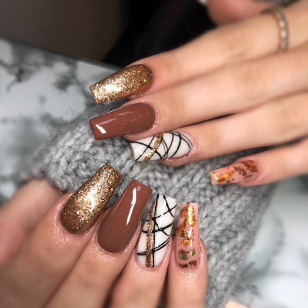 Henna Brown Polished Nails With White And Gold Design Women