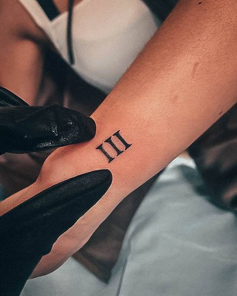 Lady With Elegant Roman Numeral Tattoo Body Art