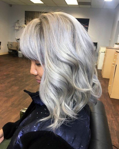 Lady With Full Bodied Grey Haired Manicured Layered Fashioned Hairstyle