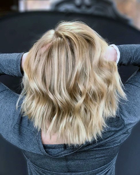 Layered And Textured Blonde Highlighted Wavy Shoulder Length Hair For Girls