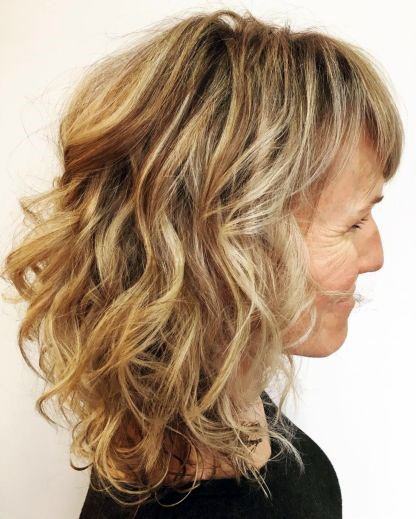 Layered Waves Blonde Hairstyles For 50 Year Old Woman With Thick Hair