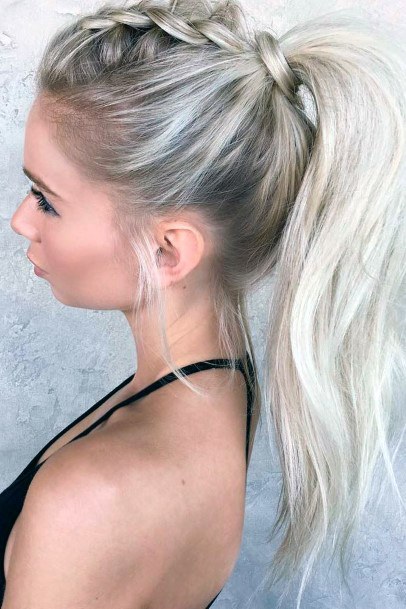 Light Blonde Female With Center Braid Into Loose Ponytail With Hair Tie