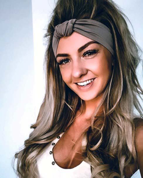 Light Brown Haired Female With Large Curls And Brown Knot Headband