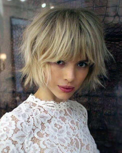 Long Shaggy Razor Textured Cut On Female With Medium Blonde Hair