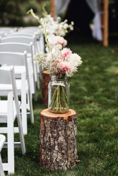 Mason Jar Placed At Aisle On Wooden Log Wedding Decorations