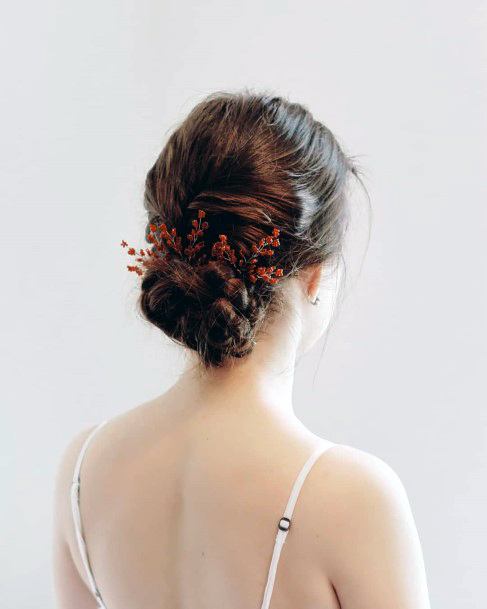 Medium Brown Haired Female With Low Messy Bun And Hair Accent