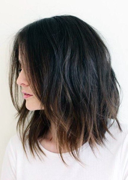 Messy Dark Hairstyle For Women With Lighter Ends And Layers