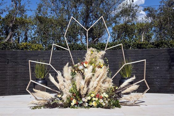 Modern Boho Gold Geometric Backdrop With Dried Grasses And Florals Wedding Arch Ideas