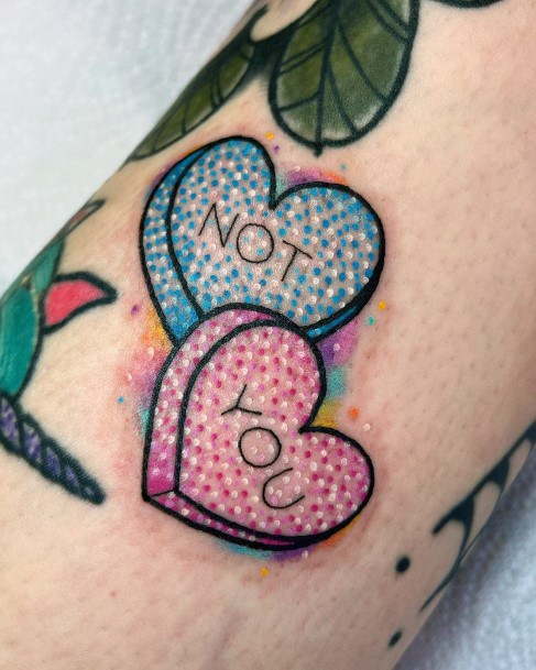 Neat Candy Heart Tattoo On Female