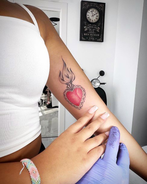 Neat Flaming Heart Tattoo On Female