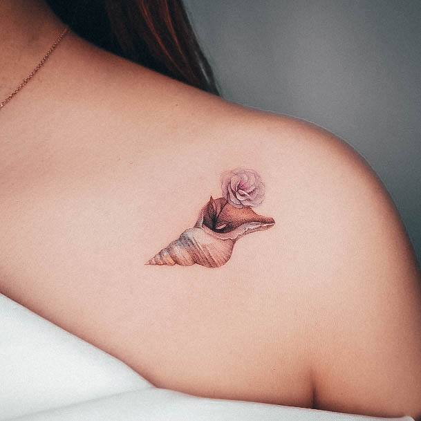 Neat Seashell Tattoo On Female