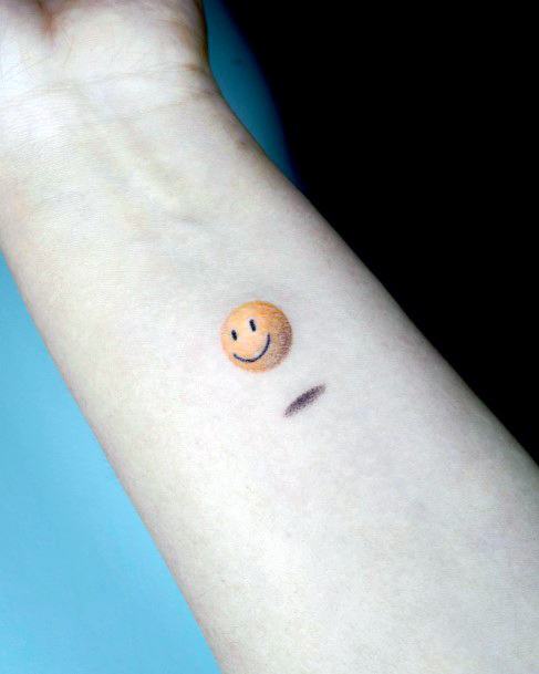 Neat Smiley Face Tattoo On Female