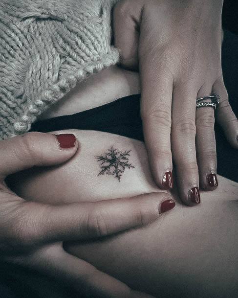 Neat Snowflake Tattoo On Female