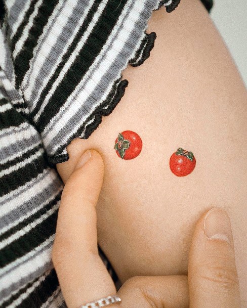 Neat Tomato Tattoo On Female